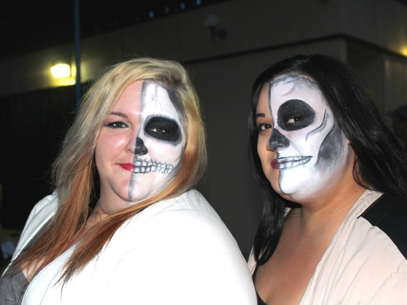 adults with skeleton face paint at halloween