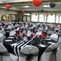 senior center multipurpose room set up with elegant red black and white decorations
