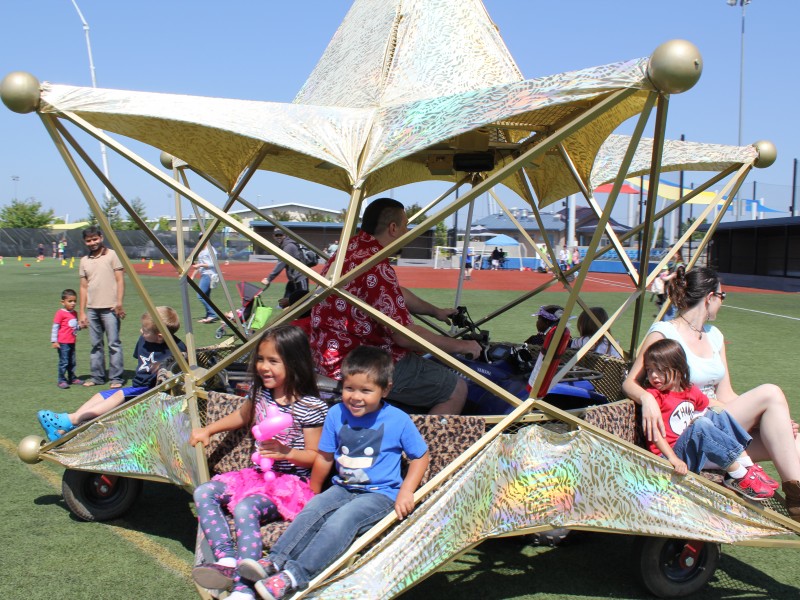 Children enjoying a star-shaped vehicle at meet the machines
